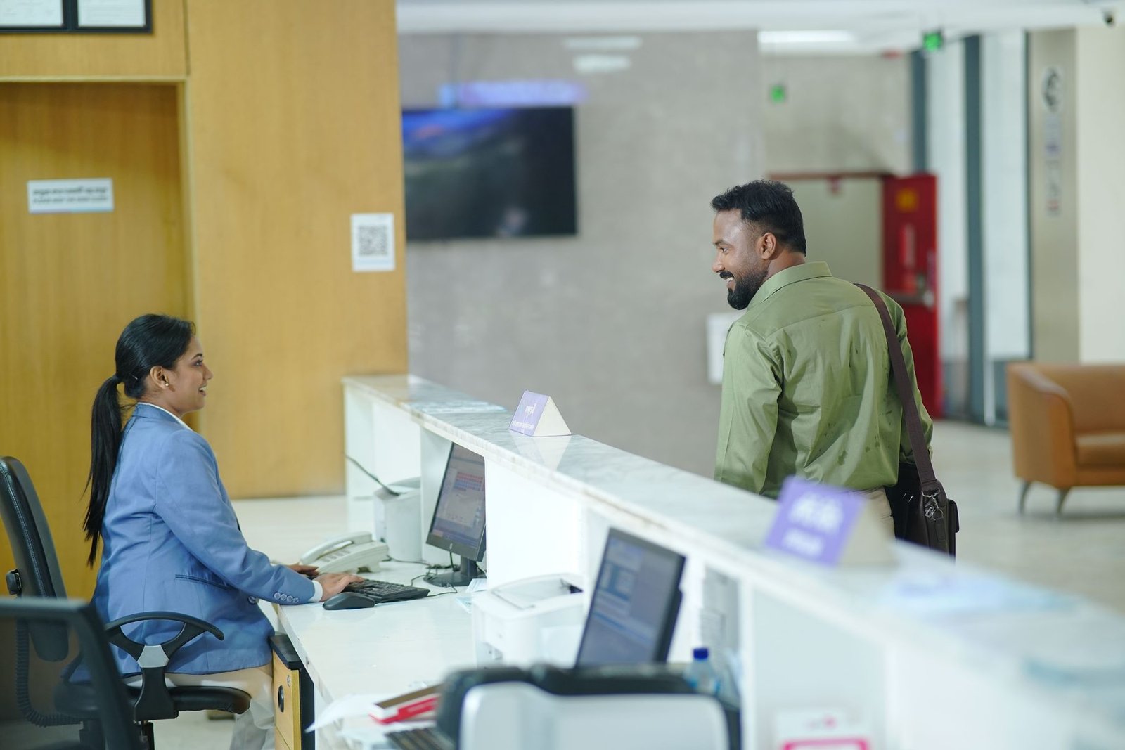 A patient checking in at the hospital front desk